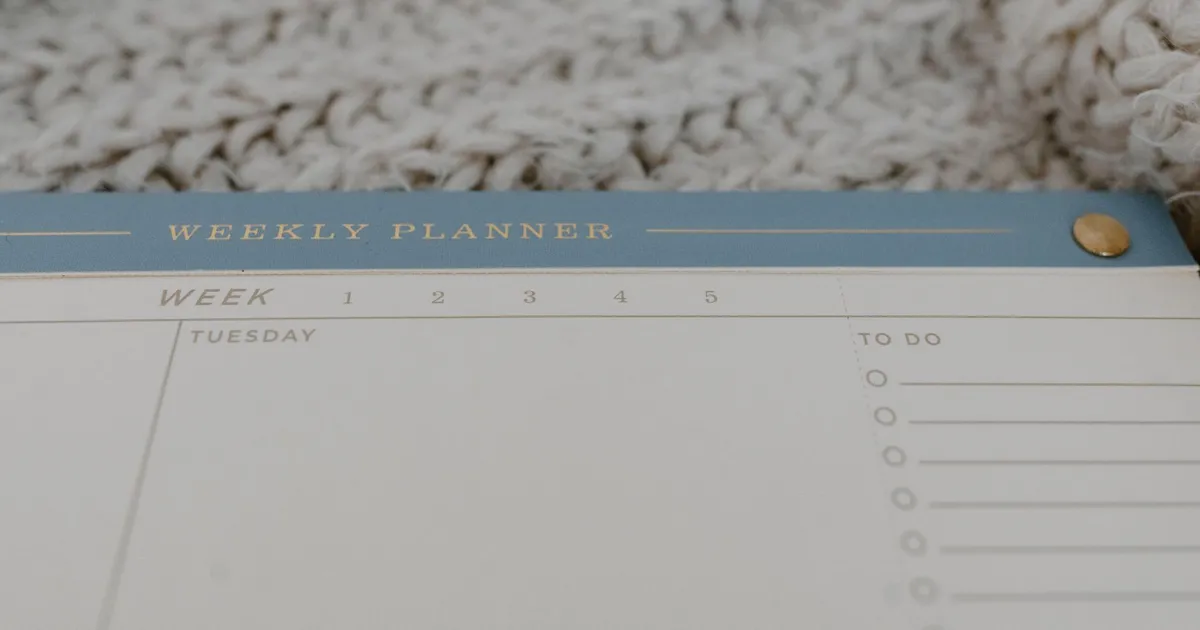 An open weekly planner with spaces for appointments and tasks